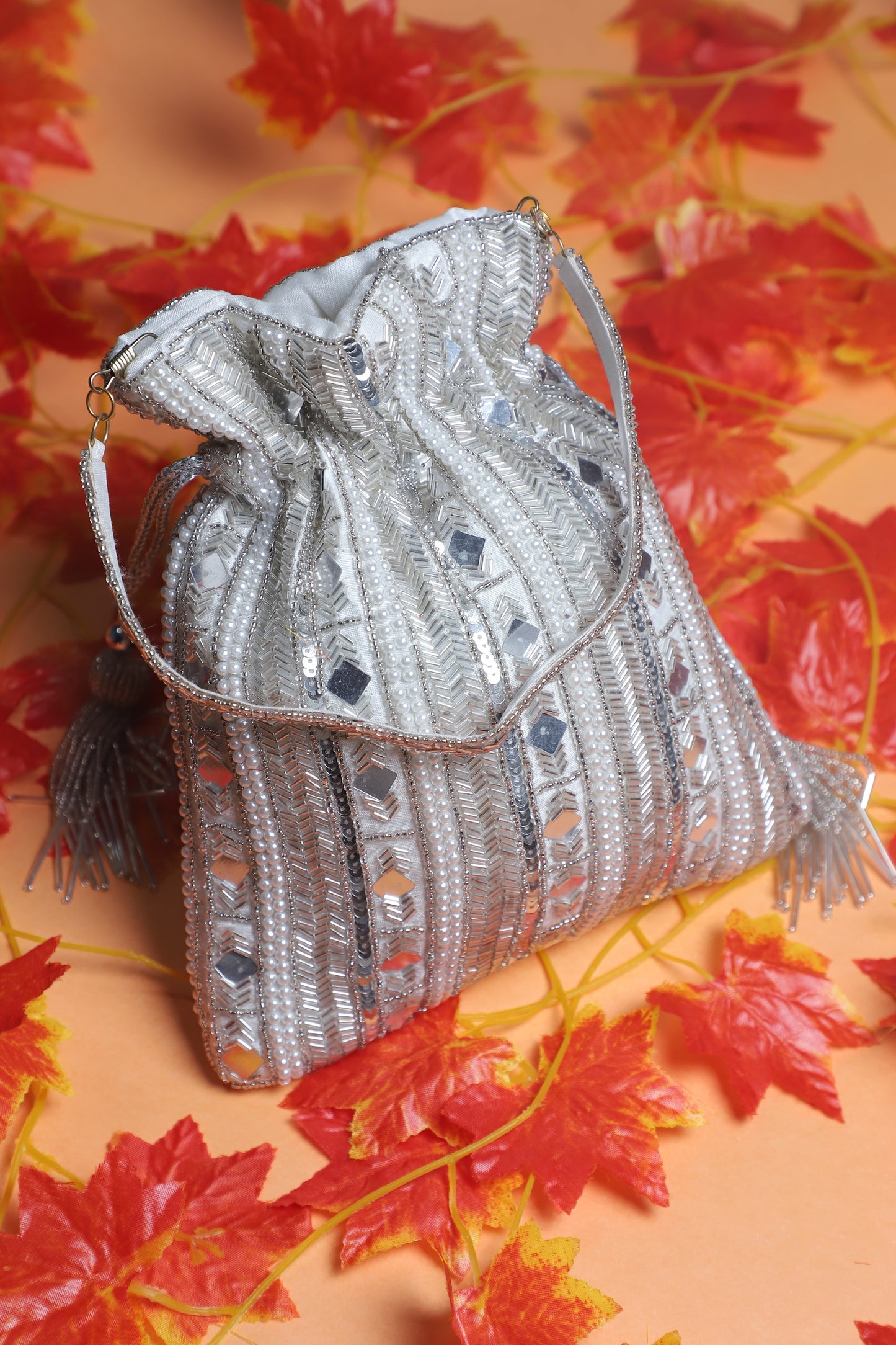 Stylish mirror sheet work silver potli bag